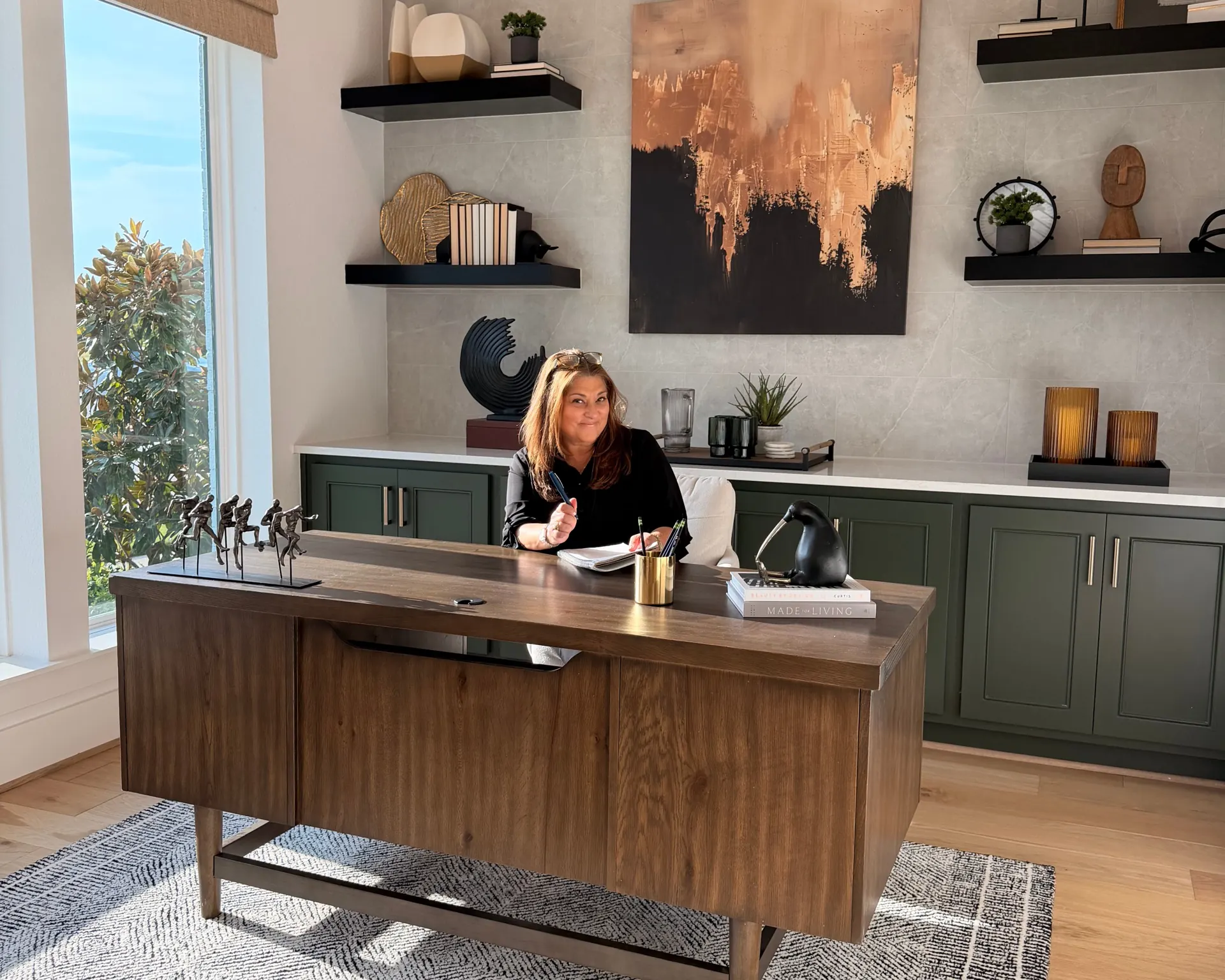 Mary De Pinho, bilingual Texas realtor, at her desk in a Greater Houston home office